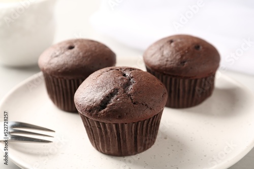 Delicious fresh chocolate cupcakes on plate  closeup