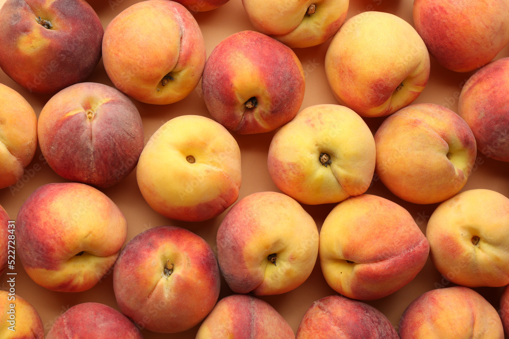 Fresh ripe peaches on beige background, flat lay Fresh ripe peaches on beige background, flat lay