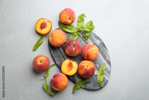 Fresh sweet peaches on light table, flat lay