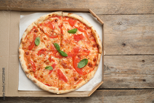 Delicious pizza Margherita on wooden table, top view
