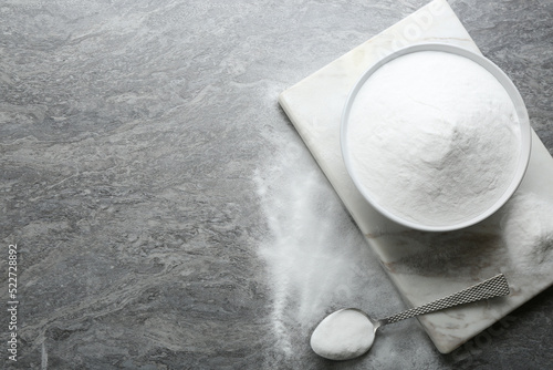 Baking soda on grey table, flat lay. Space for text