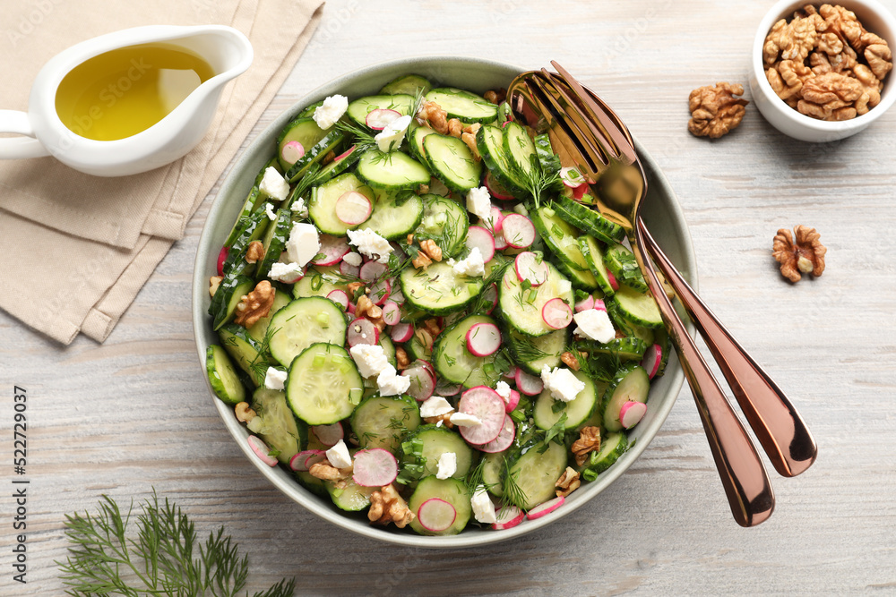 Delicious cucumber salad served on white wooden table, flat lay Delicious cucumber salad served on white wooden table, flat lay
