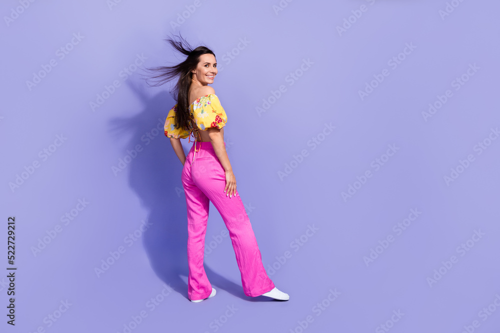 Full length photo of sexy pretty girl dressed off shoulders blouse wind blowing walking empty space isolated purple color background