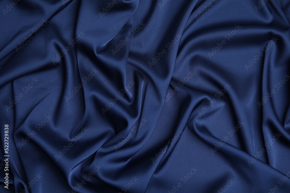 Crumpled dark blue silk fabric as background, top view Crumpled dark blue silk fabric as background, top view