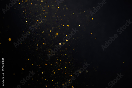 Golden glitter bokeh sparkles lights dark abstract overlay background photo