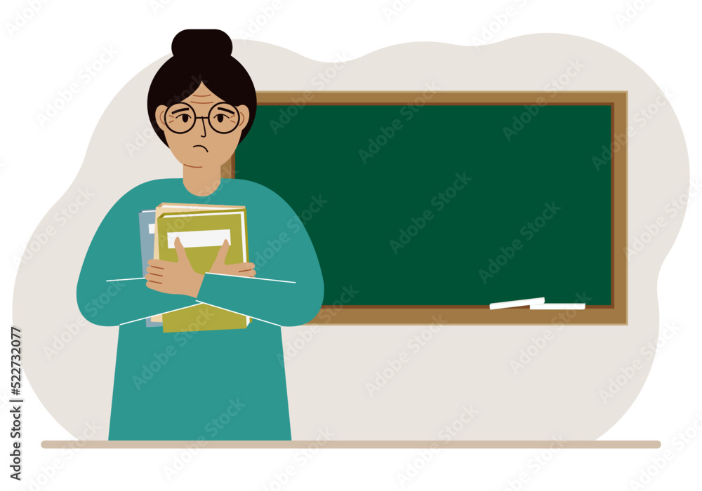 Female teacher with books on the background of the school board. Female teacher with books on the background of the school board.