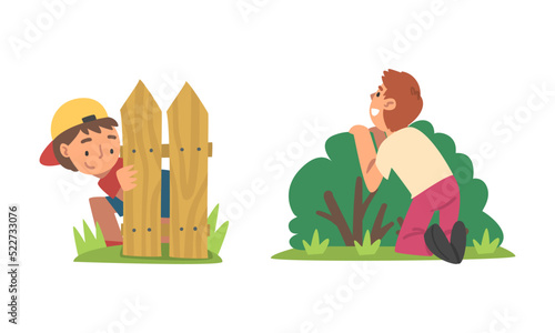 Kids playing hide and seek set. Boys hiding behind wooden fence and green bush cartoon vector illustration