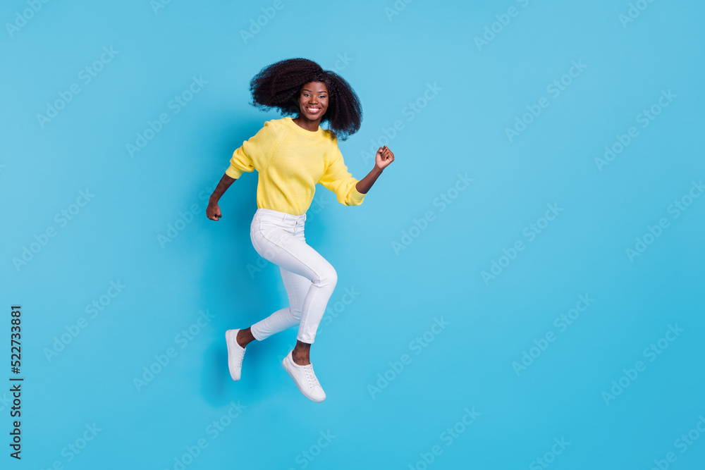 Full length photo of young happy girl running fly going shopping have free time isolated on blue color background