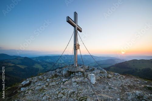 The summit cross at the Plankogel in Styria, Austria on an early summer morning