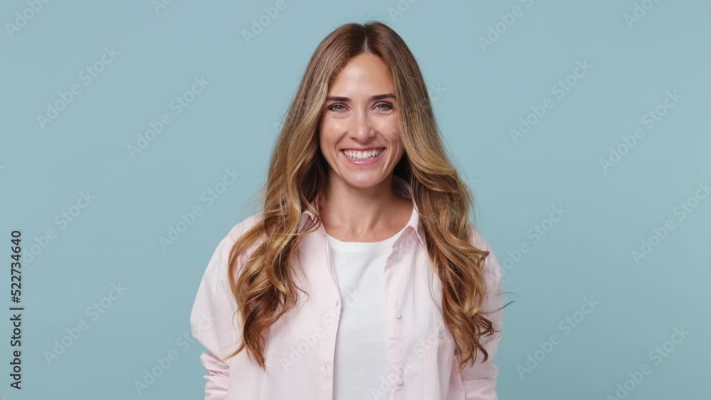 Young smiling happy cool cheerful friendly positive calm caucasian woman 30s wear pink shirt white t-shirt looking camera isolated on plain pastel light blue cyan background People lifestyle concept Young smiling happy cool cheerful friendly positive calm caucasian woman 30s wear pink shirt white t-shirt looking camera isolated on plain pastel light blue cyan background People lifestyle concept