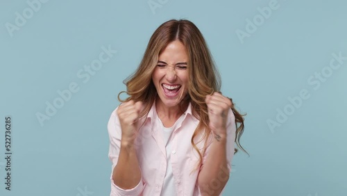 Young woman 30s wear pink shirt countdown 1 2 3 one two three go celebrate win scream rejoices doing winner hands gesture isolated on plain pastel light blue cyan background. People lifestyle concept