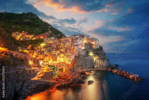 Tableau sur toile Fantastic morning view of Manarola city with costal rocks on a foreground