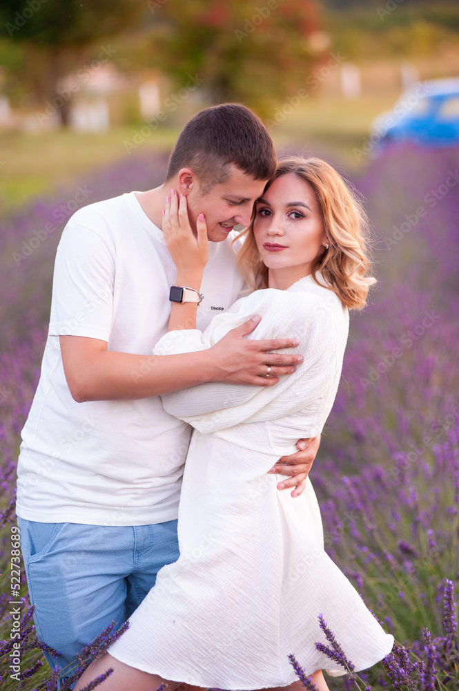 Young couple in love bride and groom, wedding day in summer. Enjoy a moment of happiness and love in a lavender field.