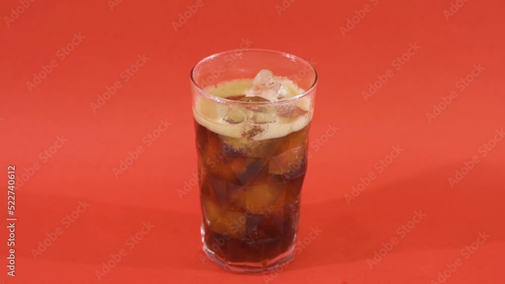 Coke glass full of ice cubes.
Slow motion video. He pours cola into a glass with ice.
Coke glass full of ice cubes.
Slow motion video. He pours cola into a glass with ice.