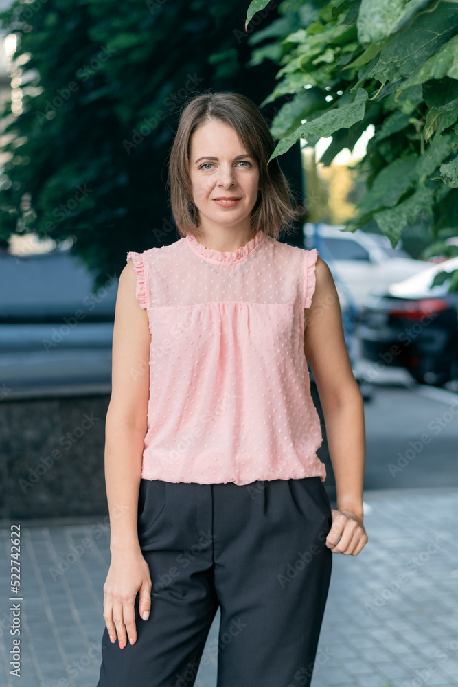 Portrait of young woman in formal business clothing outside. Successful business woman. Portrait of young woman in formal business clothing outside. Successful business woman.