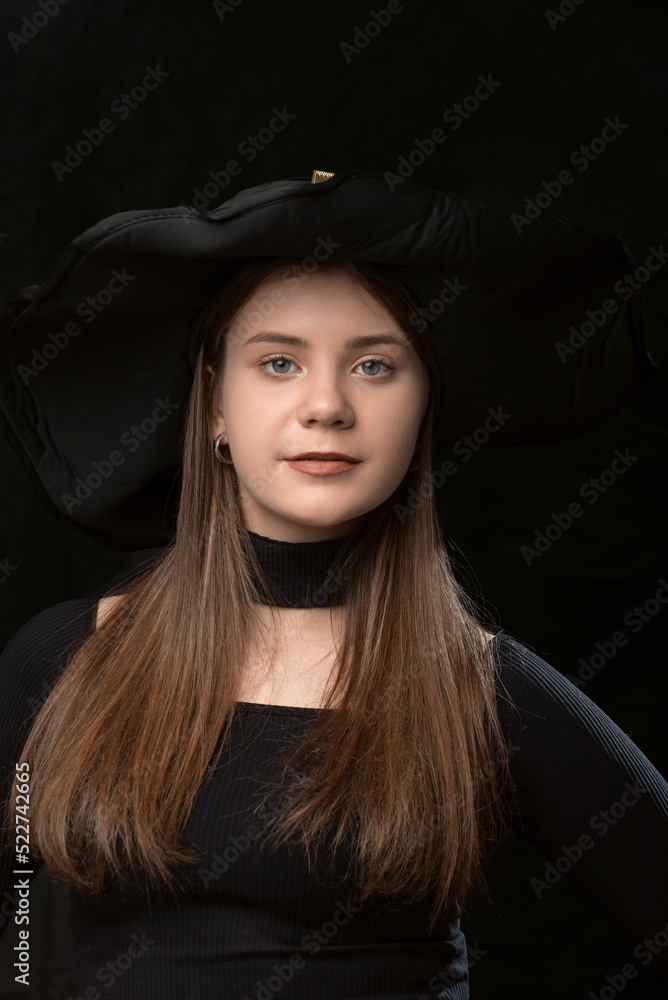 Portrait close up of young girl in black clothes and wide-brimmed hat. Young lady aristocrat. Portrait close up of young girl in black clothes and wide-brimmed hat. Young lady aristocrat.