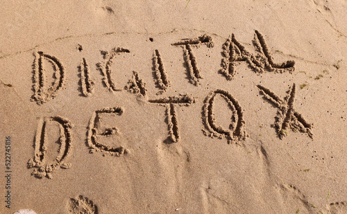 Digital detox lettering on the beach.