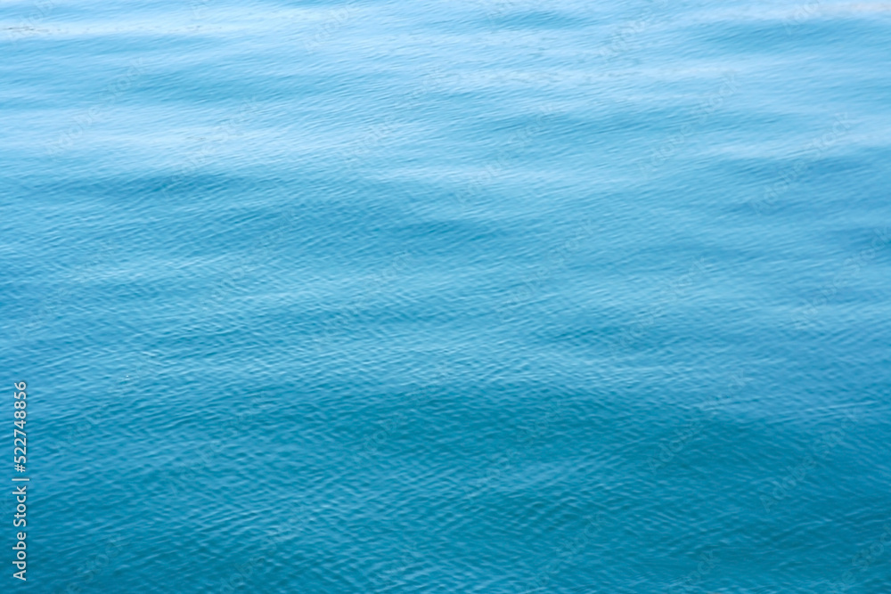 Obraz premium Turquoise blue colored calm sea surface texture.