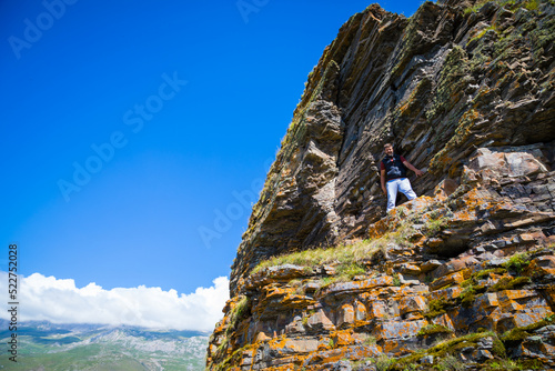 A man stands on top of a mountain, North Ossetia, the village of Kamunta photo