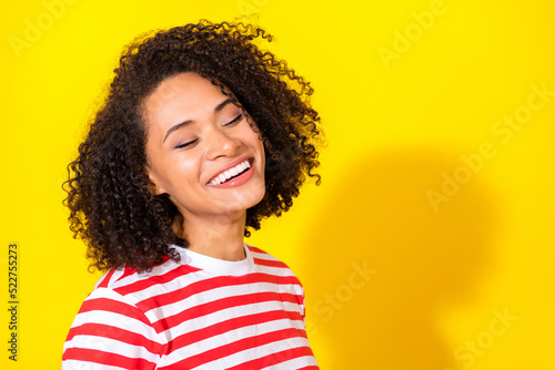 Photo of brunette funny lady near empty space wear red t-shirt isolated on vibrant yellow color background © deagreez