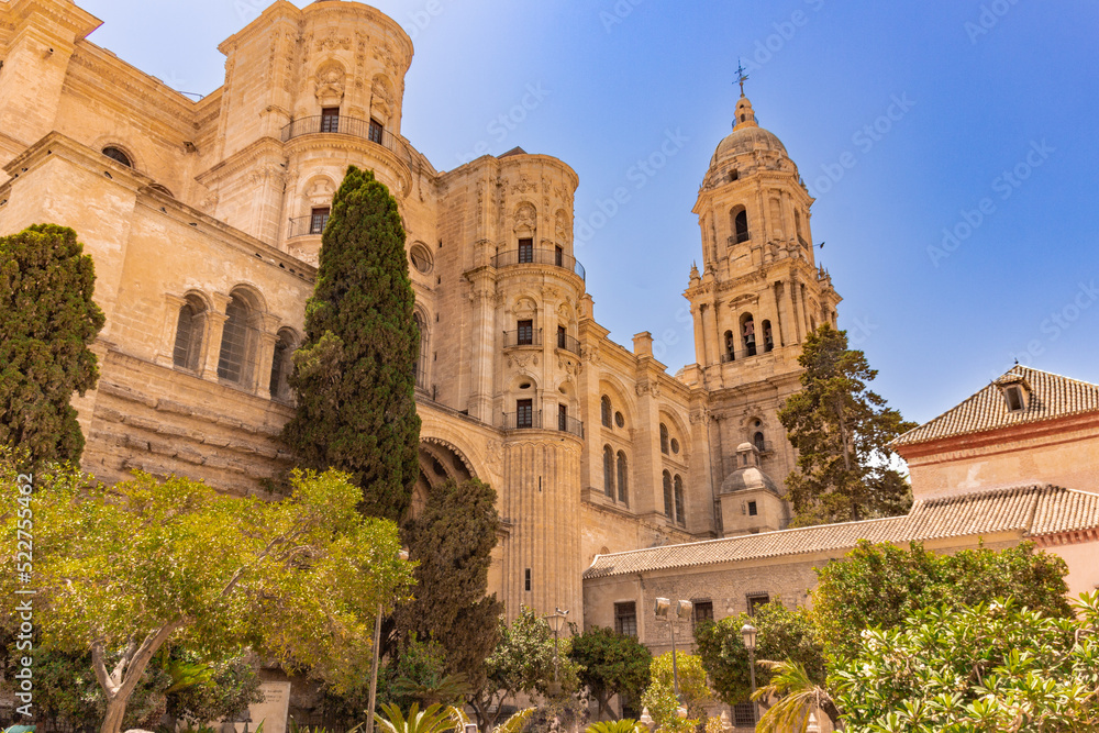 side view of Malaga cathedral with trees in the foreground