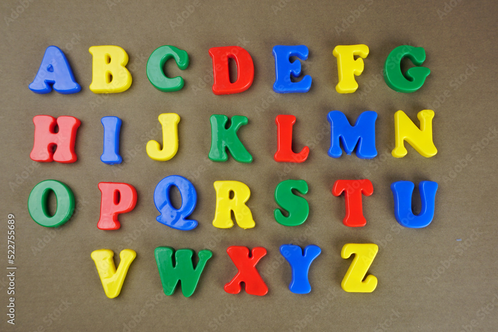 Fototapeta premium Alphabet on color background. School and education concept. Empty space for text and design