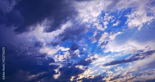 sun rays break through dark storm clouds