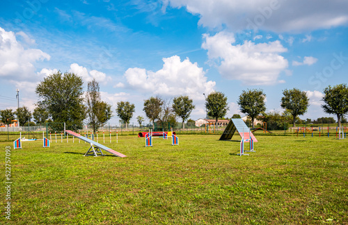 Area equipped for dog training. Dog training in a fenced area..Obstacle courses with tunnels, steep ramp, slides, poles and high jump.