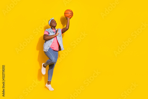 Photo of sportsman lady throw basket ball championship wear stylish trendy vintage denim vest isolated vivid color background