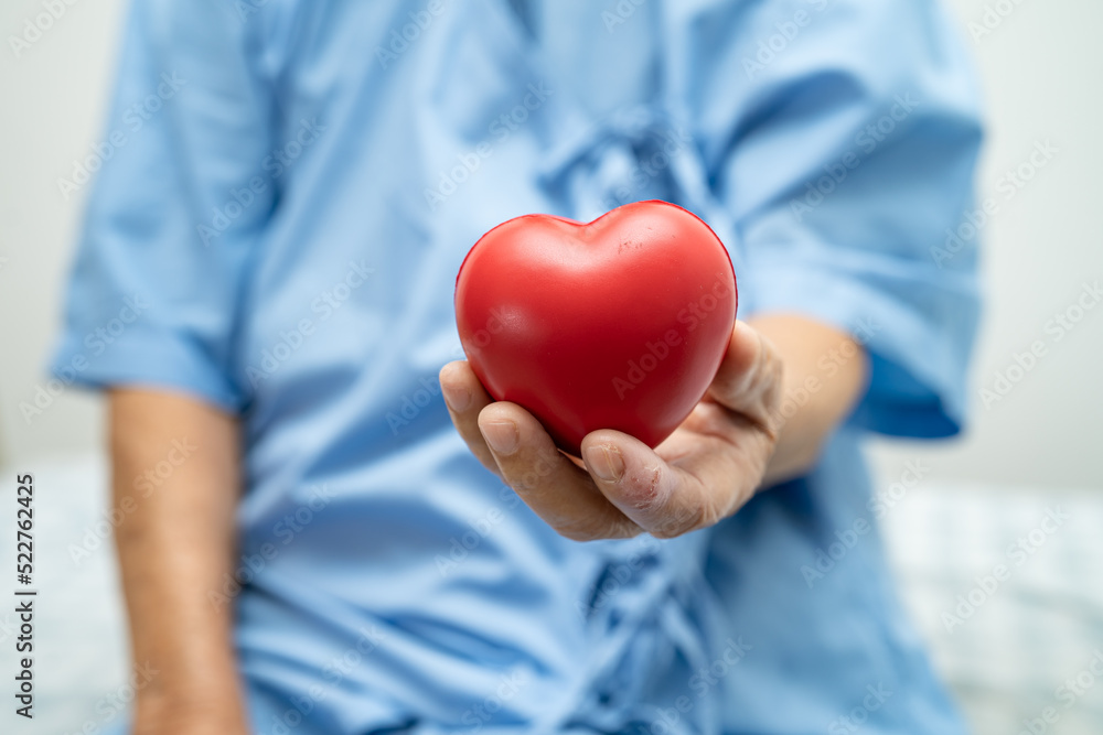 Asian senior or elderly old lady woman patient holding red heart, healthy strong medical concept. Asian senior or elderly old lady woman patient holding red heart, healthy strong medical concept.