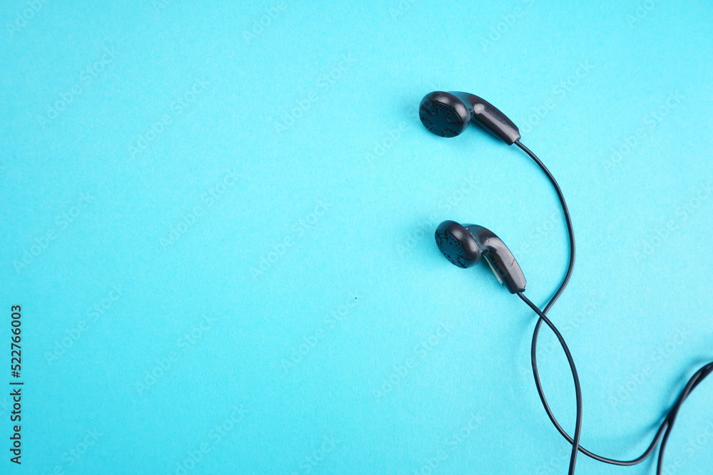 Top view of Mobile phone with headphones isolated on colorful background, Listen to music. Space for text Top view of Mobile phone with headphones isolated on colorful background, Listen to music. Space for text
