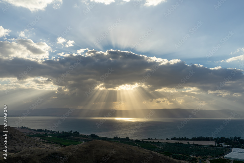 Sunlight shinning on the sea through the rain clouds. Sea of Galilee, Israel