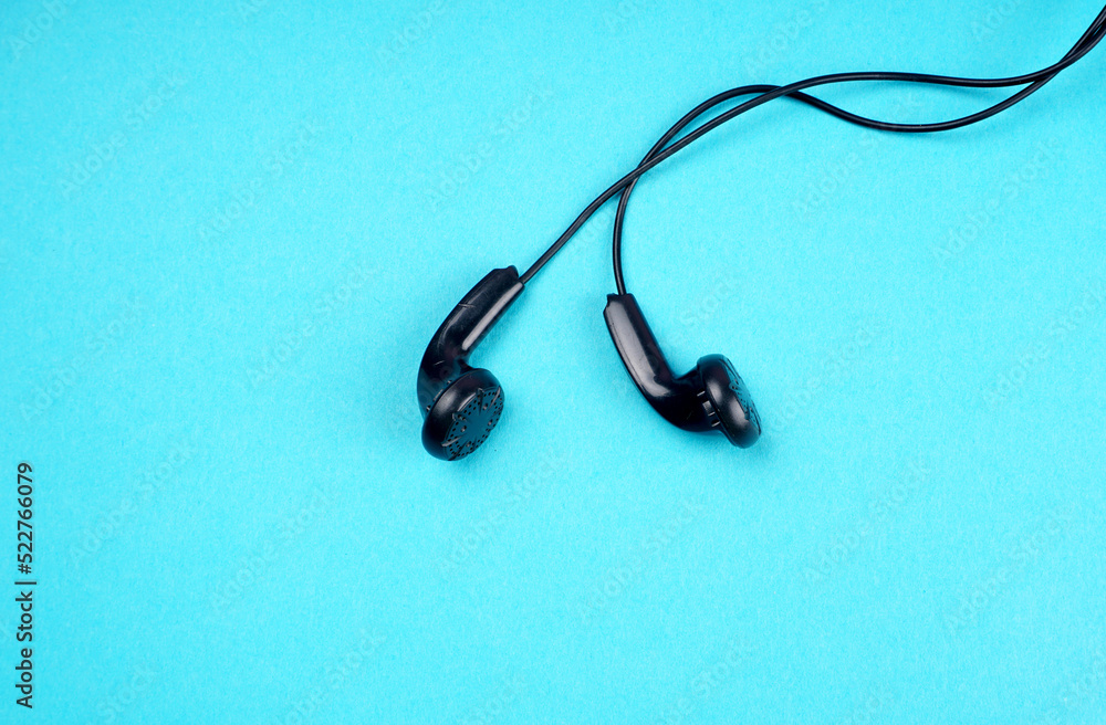 Top view of Mobile phone with headphones isolated on colorful background, Listen to music. Space for text Top view of Mobile phone with headphones isolated on colorful background, Listen to music. Space for text