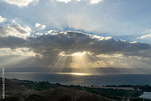 Sunlight shinning on the sea through the rain clouds. Sea of Galilee, Israel © kpeggphoto