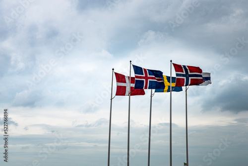 Scandinavian flags fluttering in the sky reminds of the historical Kalmar union between Sweden, Denmark, Iceland, Faroe Islands, Greenland and Norway against the Hanseatic League economical influence photo