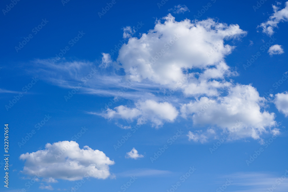 White fluffy clouds in the blue bright sky White fluffy clouds in the blue bright sky