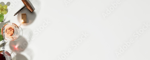 Flat-lay of red, rose and white wine in glasses on white background, banner, copy space