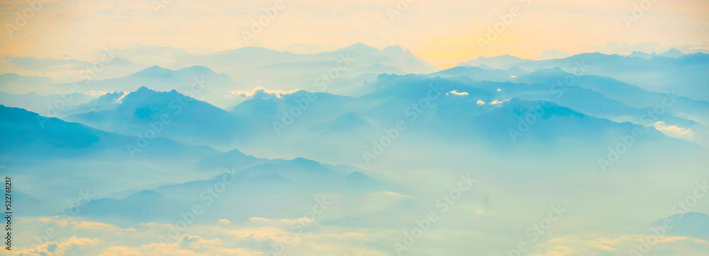 Mountains in fog sunset panorama landscape with sunset sky