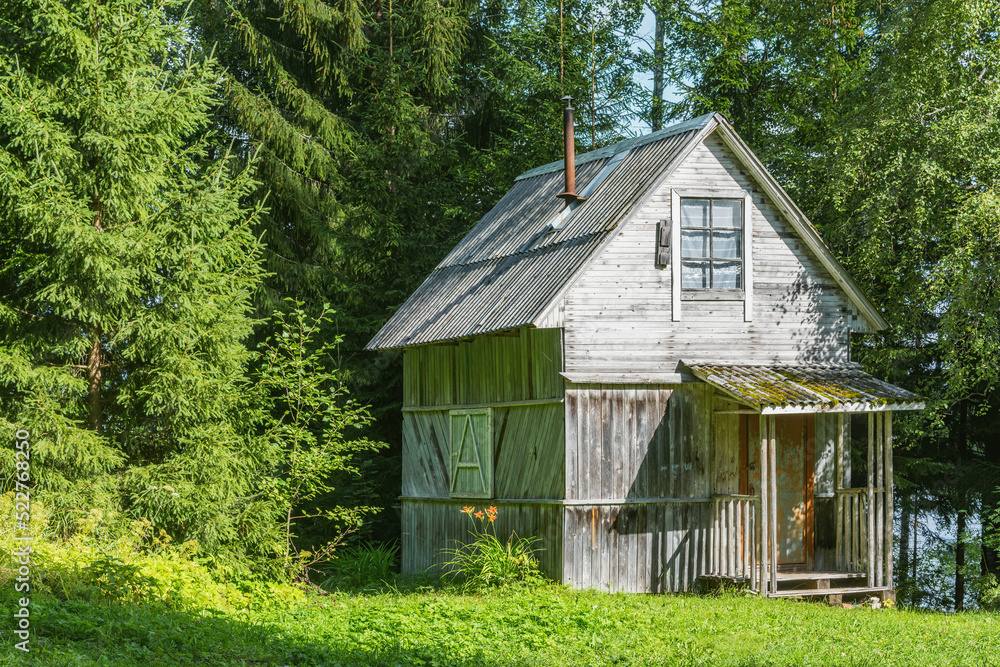 Ancient wooden house in the summer forest. Ancient wooden house in the summer forest.