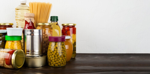 Emergency survival food set on dark wooden kitchen table