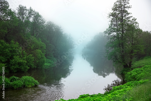 Morning fog over the river. A mystical place. Foggy landscape. Forest river.