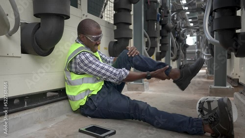 African male engineer suffered a knee injury at work.