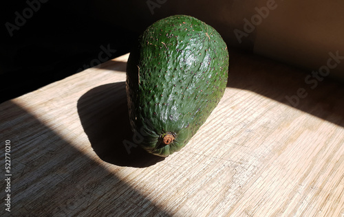 Close up on a ripe whole green avocado