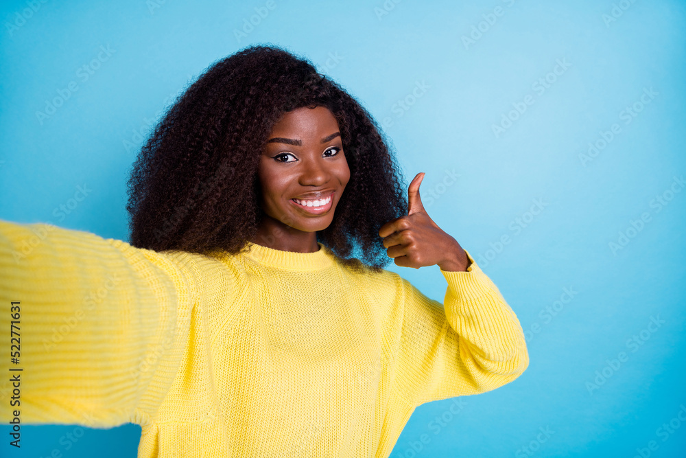 Photo of attractive girl wear stylish clothes show approve symbol enjoy quality yellow pullover isolated on blue color background Photo of attractive girl wear stylish clothes show approve symbol enjoy quality yellow pullover isolated on blue color background