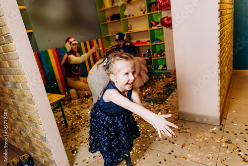 child girl playing animators throwing shiny metofan photo