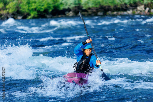 Whitewater kayaking banner, extreme sport rafting. Young woman in kayak sails mountain river © Parilov