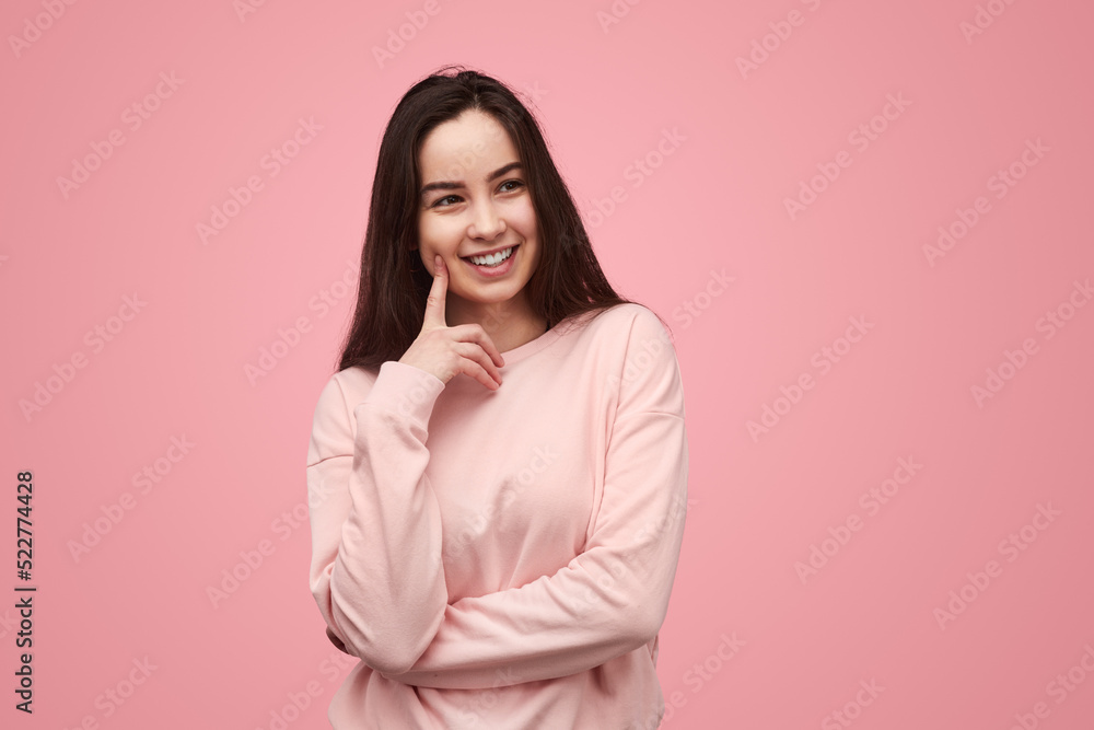 Teen brunette smiling and looking away Teen brunette smiling and looking away