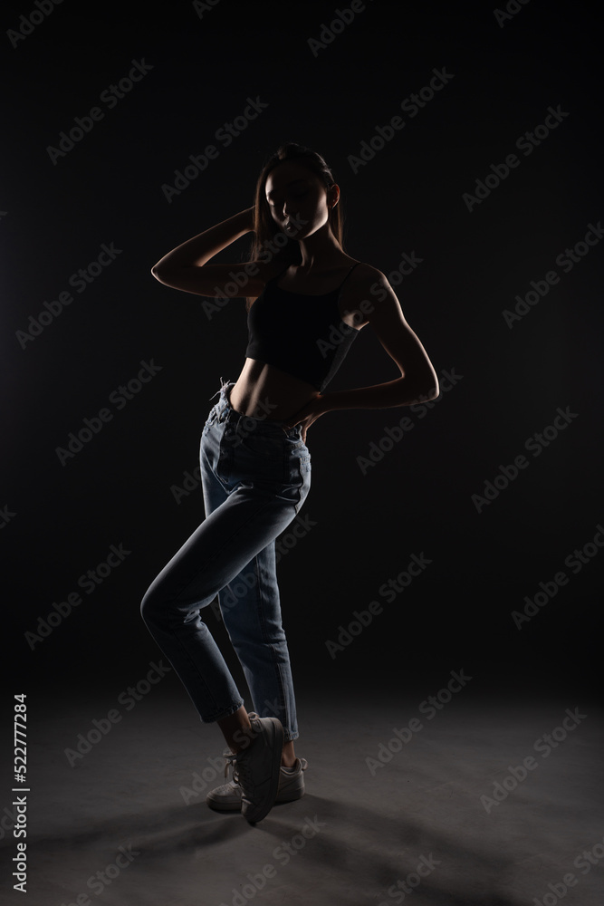 Silhouette of girl dressed casually while posing
