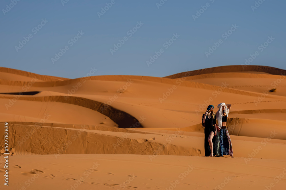 A Beautiful Model Poses In The Sand Dunes In The Great Sahara Desert In Morocco, Africa