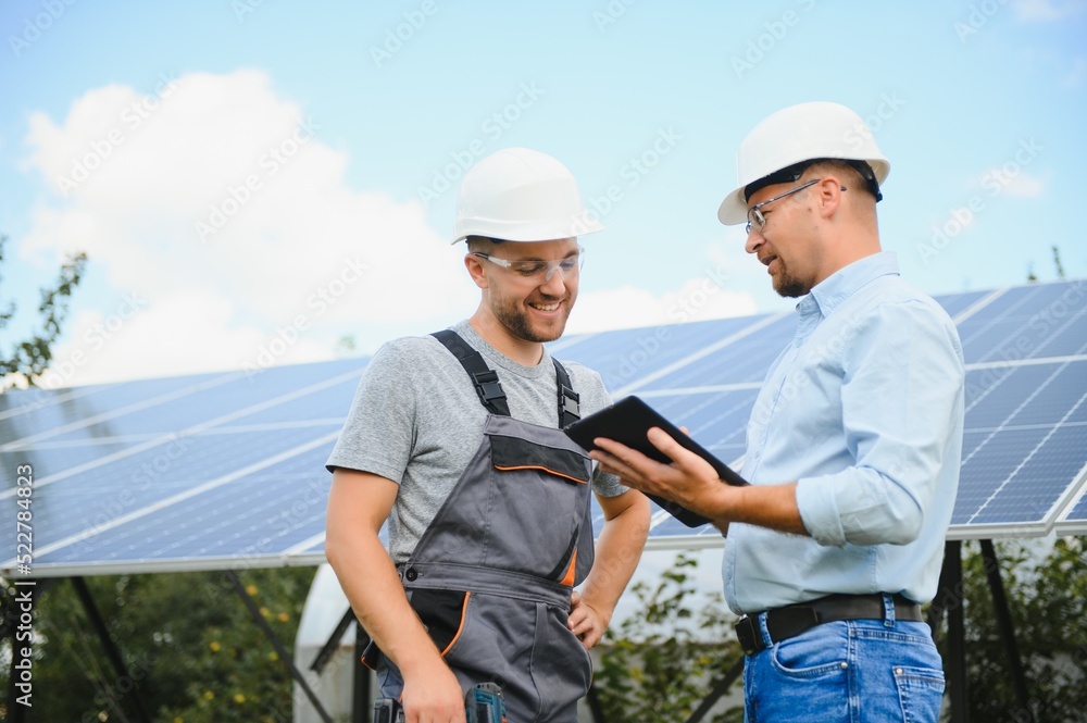 Two engineers are conducting outdoor inspection of solar photovoltaic panels Two engineers are conducting outdoor inspection of solar photovoltaic panels